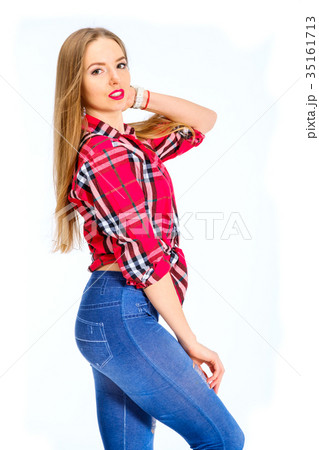 Young sexy woman dressed in jeans and checkered Young sexy woman dressed in jeans and checkered 35161713