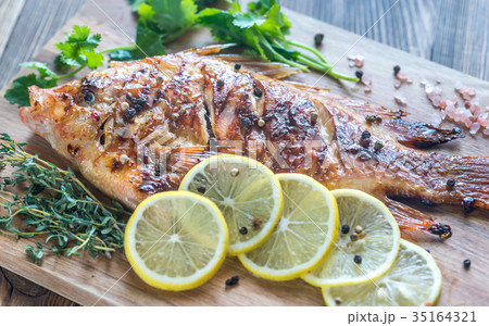 Grilled Tilapia with herbs on the wooden board Grilled Tilapia with herbs on the wooden board 35164321