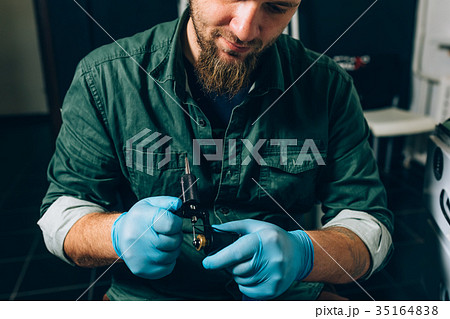tattoo master artist prepares tools for tattooing 35164838
