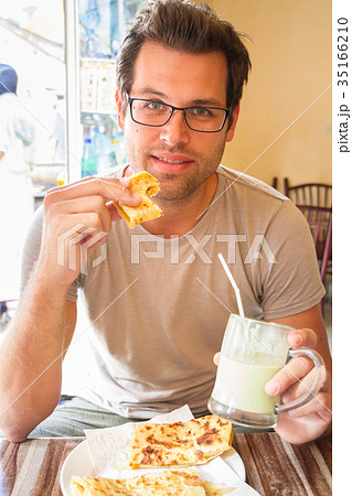 Man eating traditional moroccan breakfast in Man eating traditional moroccan breakfast in 35166210