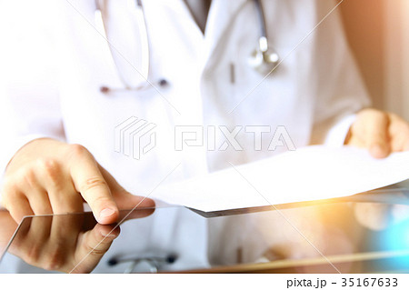 doctor working on a computer at his cabinet 35167633