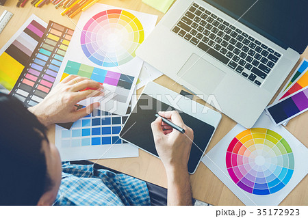 Graphic designer drawing on graphics tablet 35172923