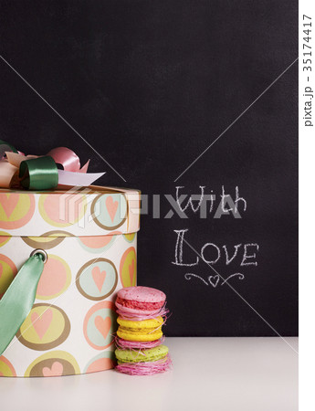 gift box and sweet macaroons on chalkboard gift box and sweet macaroons on chalkboard 35174417
