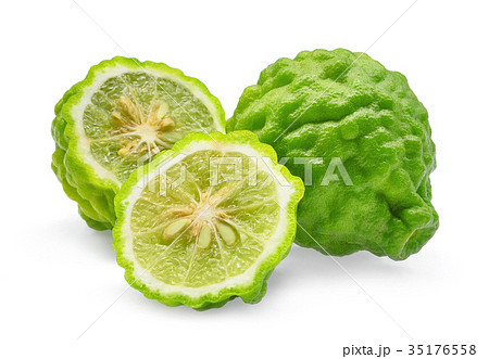 whole and half of green fresh bergamot isolated  35176558
