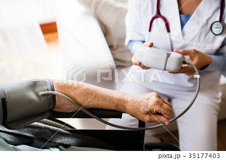 Unrecognizable health visitor and a senior woman Unrecognizable health visitor and a senior woman 35177403