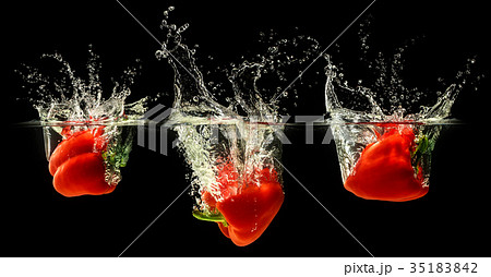 Red bell pepper falling in water Red bell pepper falling in water 35183842