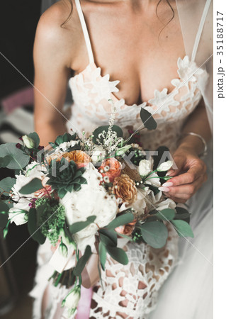 Bride holding big and beautiful wedding bouquet Bride holding big and beautiful wedding bouquet 35188717