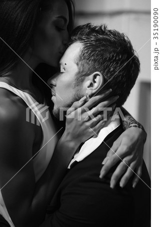 Beautiful, young couple posing on camera indoors 35190090