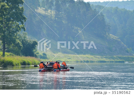 Team of people float down the River on inflatable Team of people float down the River on inflatable 35190562