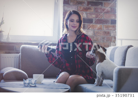 woman with cup of tea or coffee sitting at sofa woman with cup of tea or coffee sitting at sofa 35190731