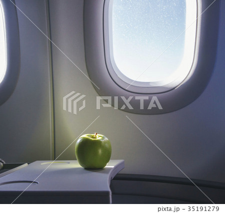 a green apple on the table of airplane 35191279