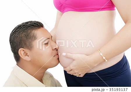 man kissing the belly of his lovely pregnant wife man kissing the belly of his lovely pregnant wife 35193137