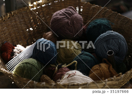 Coats with colored wool in a basket 35197666