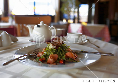 Salad in a plate on a table Salad in a plate on a table 35199319