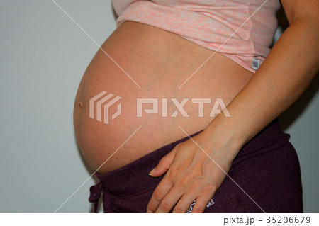 pregnant woman touching her big belly. Close up. pregnant woman touching her big belly. Close up. 35206679