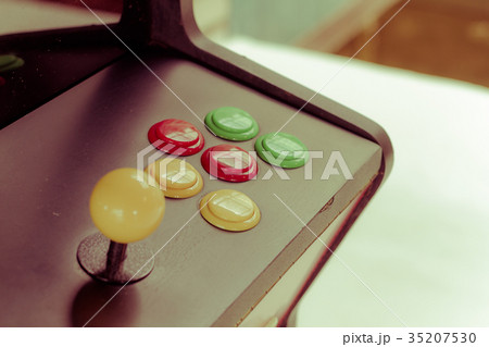 yellow joystick of an old arcade video game 35207530
