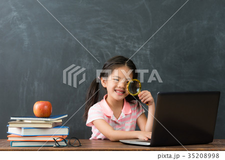 happy beautiful female kid holding magnifying 35208998