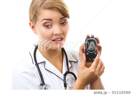 Shocked woman holding glucometer 35210300