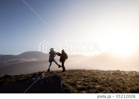 Senior couple on a walk in an autumn nature. 35212026