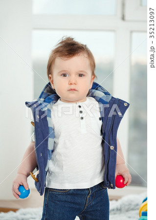 Funny serious baby toddler boy at home 35213097