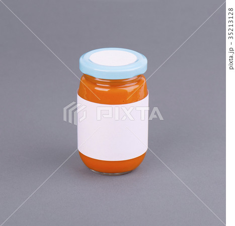 Orange glass jar for baby food bank on grey 35213128