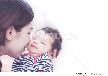 mother hugging and kissing her newborn baby girl mother hugging and kissing her newborn baby girl 35213736