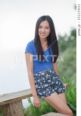 Asia young shy women sitting and smile on wood long chair 35215031