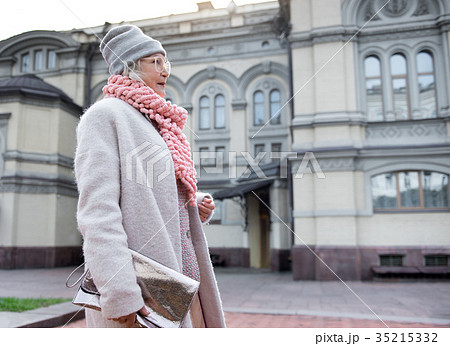 Fashionable mature lady enjoying walk in city 35215332