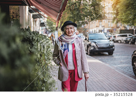 Rich senior woman walking in town Rich senior woman walking in town 35215528