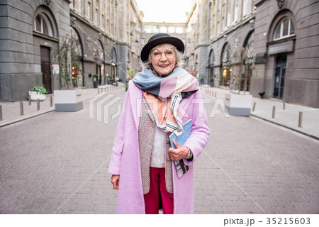 Happy mature woman traveling in town with Happy mature woman traveling in town with 35215603