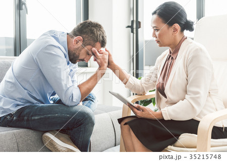 Serious female psychologist sitting near man 35215748