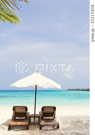 White parasol with sun chairs White parasol with sun chairs 35215939