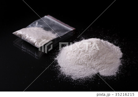 Cocaine in plastic packet on black background Cocaine in plastic packet on black background 35216215