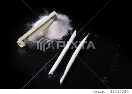 Rolled hundred dollars banknote and cocaine 35216220