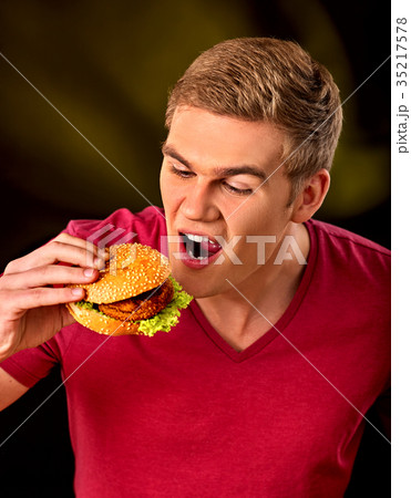 Man eat hamburger. Fastfood and junk food concept. 35217578
