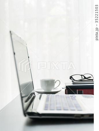 Laptop placed on desktop with coffee cup 35221503