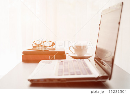 Laptop placed on desktop with coffee cup 35221504