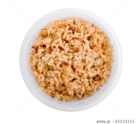 top view of brown rice in plastic cup isolated  35223151