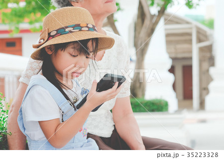 Asian child girls are playing mobile phone 35223328