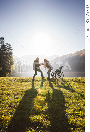 Senior couple with wheelchair in autumn nature. 35225342