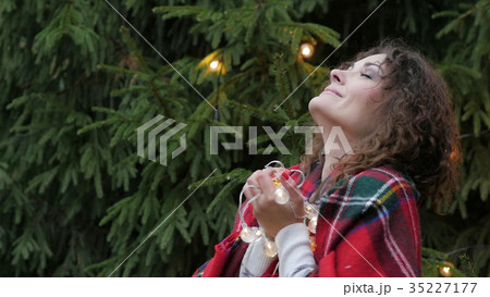 Christmas garland in the hands of a young woman on Christmas garland in the hands of a young woman on 35227177