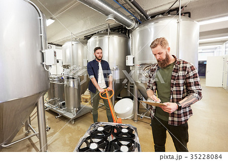 men with beer kegs on loader at craft brewery 35228084