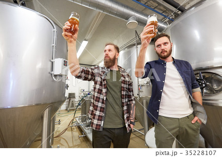 men testing non-alcoholic craft beer at brewery 35228107