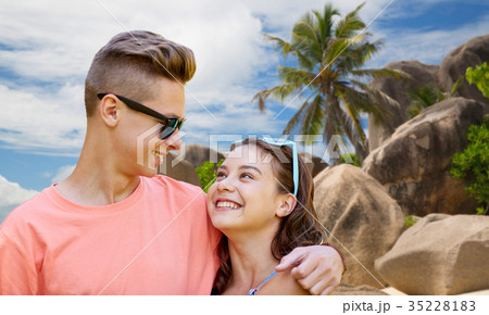happy teenage couple hugging at summer beach 35228183