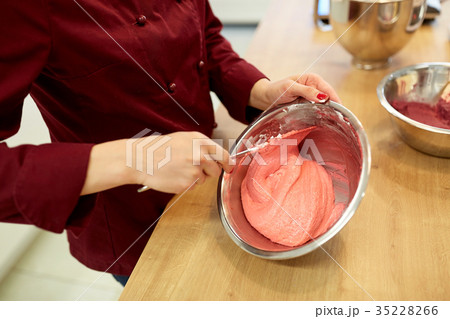 chef making macaron batter at confectionery chef making macaron batter at confectionery 35228266