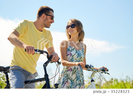 happy couple with bicycles at country 35228325