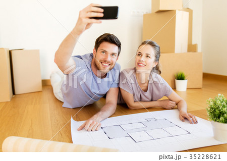 couple with boxes and blueprint moving to new home couple with boxes and blueprint moving to new home 35228621