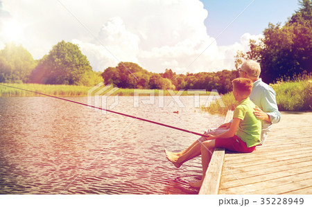 grandfather and grandson fishing on river berth grandfather and grandson fishing on river berth 35228949