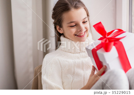 happy beautiful girl with christmas gift at home 35229015