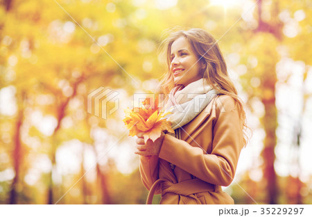 beautiful woman with maple leaves in autumn park beautiful woman with maple leaves in autumn park 35229297